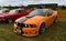 Classic Orange Ford Mustang S197 at airstrip.