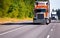 Classic orange semi truck reefer trailer on high way