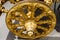 Classic ornate gold wheel on a ceremonial carriage