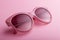 Classic oval oversized pink sunglasses closeup on pink background