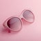 Classic oval oversized pink sunglasses closeup on pink background