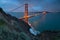 Classic panoramic view of famous Golden Gate Bridge in beautiful evening light on a dusk with blue sky and clouds in summer.