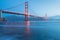 Classic panoramic view of famous Golden Gate Bridge seen from San Francisco harbour in beautiful evening light on a dusk.