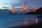 Classic panoramic view of famous Golden Gate Bridge seen from scenic Baker Beach in beautiful golden evening light on sunset.