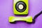 Classic phone with handset. vintage green telephone with phone receiver isolated on purple background. old communication