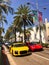 A classic photo of Rodeo Drive street with yellow Audi R8 V10 Plus and red Bburago Ferrari 458