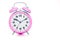 Classic pink table alarm clock on a white background