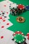 Classic playing cards, chips, red dice, bitcoin and dollars on green background.