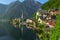 .Classic postcard view of famous Hallstatt lakeside town, Austria. Scenic panoramic view of beautiful town reflecting in