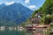 Classic postcard view of famous Hallstatt lakeside town reflecting in Hallstattersee lake in the Austrian Alps in scenic beautiful
