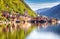 Classic postcard view of famous Hallstatt lakeside town reflecting in Hallstattersee lake in the Austrian Alps in scenic morning