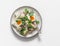 Classic potato and boiled egg salad with red onion and cilantro on a light background, top view