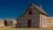 Classic prairie home in rural Idaho farm land with blue sky