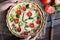 Classic quiche lorraine tart pie with broccoli, bacon and tomatoes