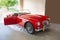 Classic red antique sports car in a garage