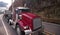 Classic red big rig semi truck with step down semi trailer trans