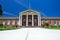 Classic Red Brick Building With Greek White Column Entrance