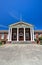 Classic Red Brick Building With Greek White Column Entrance