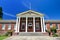 Classic Red Brick Building With Greek White Column Entrance