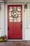 Classic red door to a white home