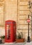 Classic red phone booth and vintage signpost.