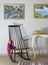 Classic rocking chair and two old books on old style vintage table, and two hanged paintings with clipping path for paintings
