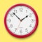 Classic round wall clock with red glossy body isolated on bright yellow background