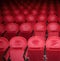 Classic rows of empty reddish seats in theatre