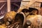 Classic rusted car covered in hay in barn