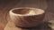 classic salted potato chips falling in wooden bowl on wood table in slow motion