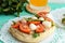 Classic sandwich with mozzarella, fresh tomatoes, arugula and sesame seeds on toast.