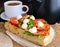Classic sandwich with mozzarella, fresh tomatoes, arugula and sesame seeds on toast