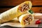 Classic shawarma with chicken and vegetables in pita bread on wooden dark background with cherry tomatoes and parsley