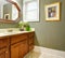 Classic simple green bathroom with wood cabinets.