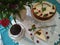 Classic simple New York cheesecake sliced on a beautifully served table with a blue tablecloth. View from the ceiling.