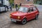 Classic small red Polish car Polski Fiat 126p driving