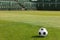 Classic Soccer Ball on Stadium Field. Row of Seats in the Stadium in the Background