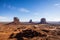 Classic southwest desert landscape under a blue sky and bright sun in Monument Valley