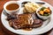 classic steak and potatoes meal, with steak seared off the flame, mashed potatoes on plate, and gravy in bowl