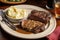 classic steak and potatoes meal, with steak seared off the flame, mashed potatoes on plate, and gravy in bowl