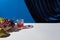 Classic still life with grape, glass with drink on white table near velour curtain isolated on blue