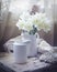 Classic still life with tender daffodils in a white vase, faded colors