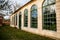 Classic style castle greenhouse with large wooden green windows, Romantic baroque chateau in sunny autumn day, Veltrusy Rococo