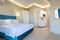 Classic style interior of white and blue bedroom with kitchen cupboard module cabinet in double suite hotel apartment flat