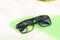 Classic Sunglasses design for men and ladies with black lenses and black frame shoot outside in a summer day closeup