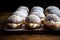 Classic Swedish semla buns with whipped cream, sprinkled with powdered sugar and sesame seeds