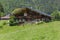 Classic swiss chalet in the middle of green alpine meadows . Cozy rural village Champery in Switzerland. The slopes of the