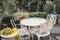 Classic table set in the garden. Vintage luxury victorian style mable stone table chair at outdoor gothic garden backyard summer
