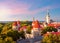 Classic Tallinn cityscape with St. Olav`s church and old town walls and towers at sunset, Estonia