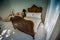 Classic teak wood bed furniture in the warm and cozy bedroom, ne